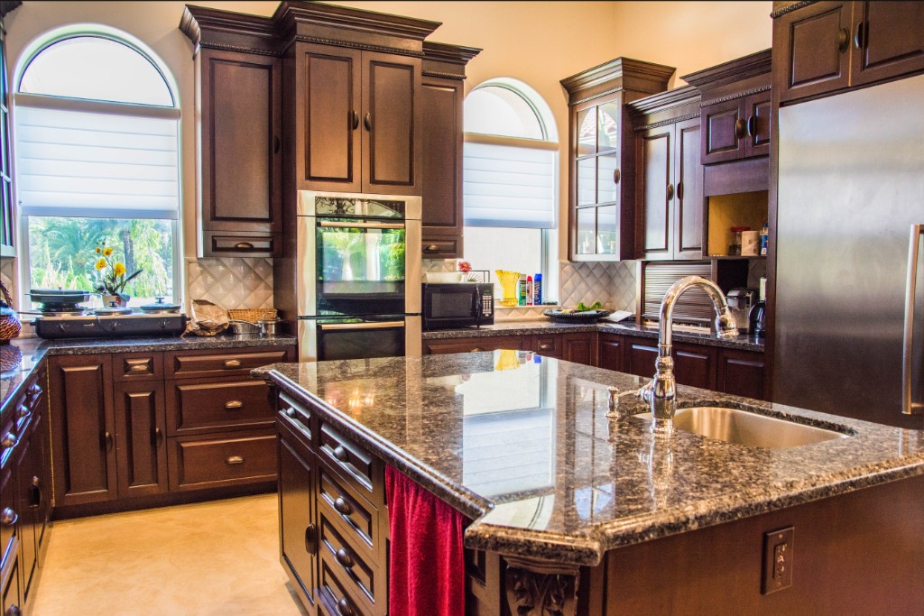 estate-chefs-kitchen Gourmet chef's kitchen with granite island and custom wood cabinetry