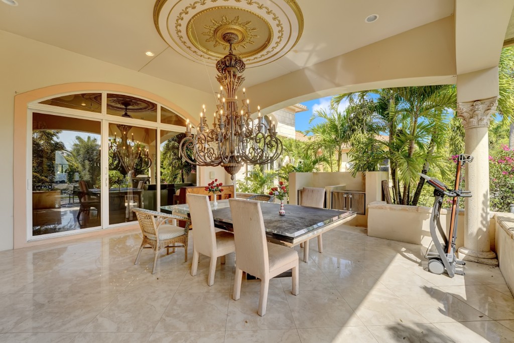 estate-covered-loggia Covered loggia with ornate chandelier overlooking the gardens
