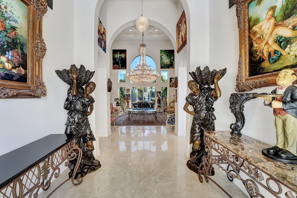 estate-entrance-gallery-hall Grand entrance hall with marble floors and curated fine-art collection