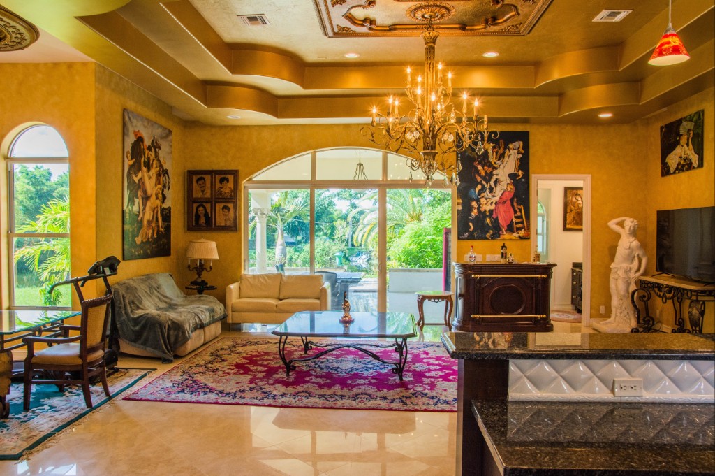 estate-family-lounge Family lounge with coffered gold ceiling and crystal chandelier